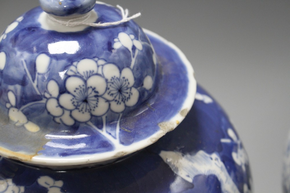 A pair of late 19th century Chinese prunus pattern baluster vases and covers, height 29cm